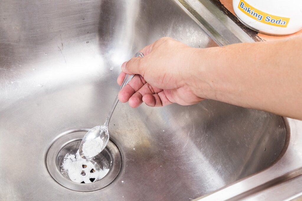 unclogging drain with baking soda and vinegar
