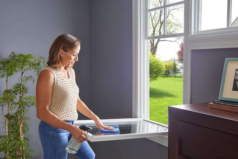 woman cleaning a window